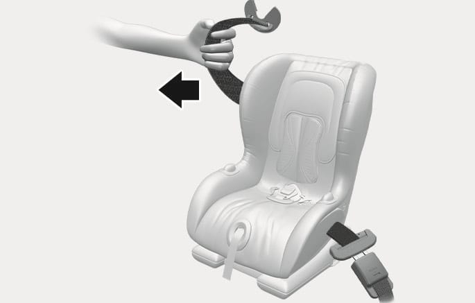 2025 Hyundai Tucson Child Restraint System installation image. A hand pulls the seat belt strap in the direction of a black arrow to tighten the belt around the child safety seat. Explains the process of firmly securing the child restraint system by removing slack from the seat belt.