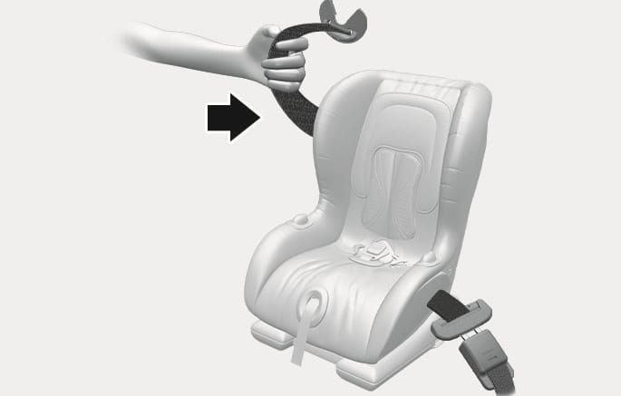 2025 Hyundai Tucson Child Restraint System installation image. A hand pulls the seat belt webbing in the direction of a black arrow to tighten it around the child safety seat. This explains how to firmly secure the child restraint system using the vehicle's seat belt.