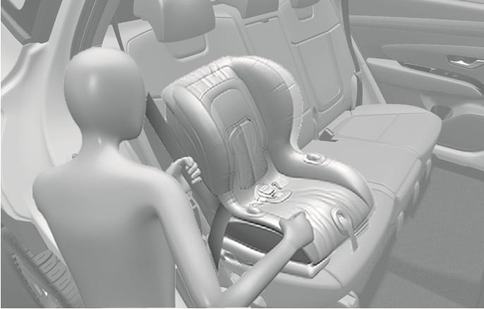 2025 Hyundai Tucson Child Restraint System security check image. A figure is shown gripping the installed child safety seat on the rear seat with both hands. Explains the process of verifying that the child restraint system is securely attached by pushing and pulling the seat forward and from side-to-side.