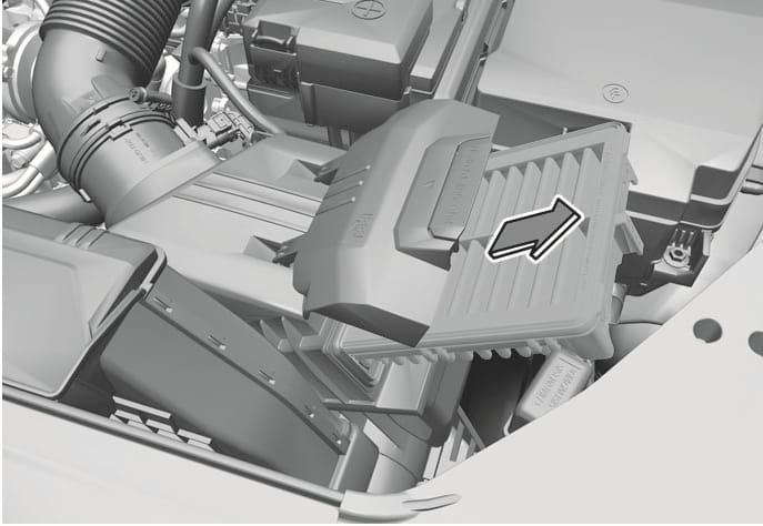 2025 Hyundai Tucson air cleaner filter replacement image. The air cleaner filter is shown being pulled out of the housing, indicated by a large arrow pointing to the right. This describes the action of removing the filter element.