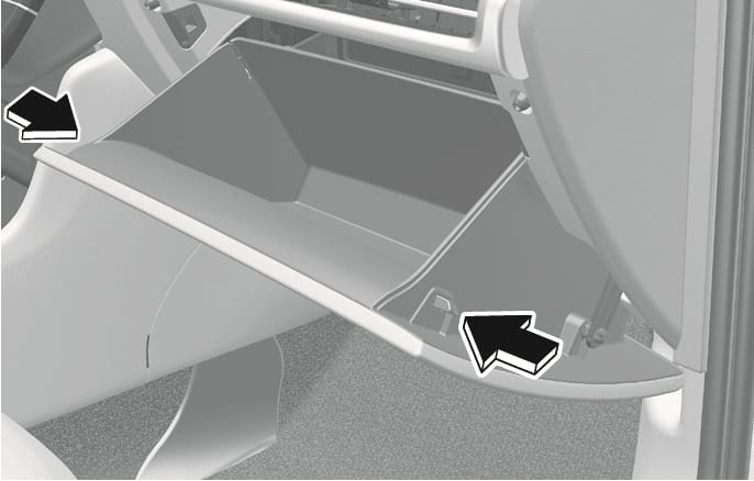 2025 Hyundai Tucson glove box disassembly image. Black arrows on the left and right sides of the open glove box point inward, indicating the direction to press the side walls. This describes the action of releasing the stoppers to lower the glove box for cabin air filter replacement.