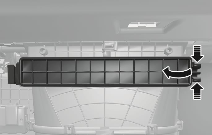 2025 Hyundai Tucson cabin air filter cover image. The rectangular filter cover is shown with a grid pattern. Two black vertical arrows on the right indicate pinching the lock clips, and a curved arrow indicates pulling the cover outward. Explains the process of unlocking and removing the cabin air filter cover.