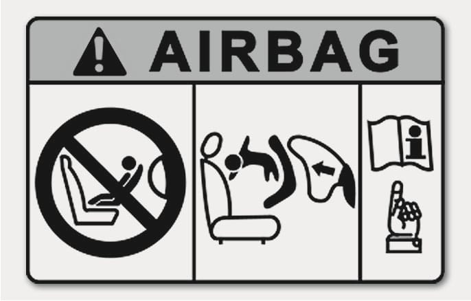2025 Hyundai Tucson Airbag Warning Label Type A image. The label displays 'AIRBAG' with a warning triangle. It depicts a prohibition symbol over a rear-facing child seat, an airbag deploying against a child seat, and a manual icon. It warns against using a rearward facing child restraint on a seat with an active airbag.