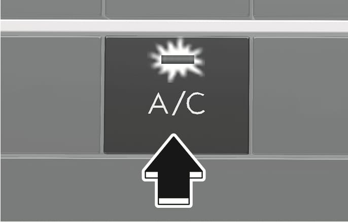 2025 Hyundai Tucson air conditioning button image. A close-up view of the button labeled 'A/C' with an indicator light symbol, highlighted by a black arrow pointing upward. Explains the function of activating the air conditioning system.