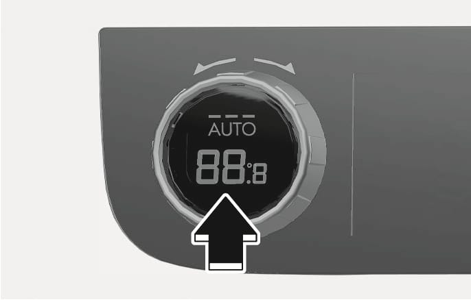 2025 Hyundai Tucson automatic climate control knob image. A circular knob features a digital display reading 'AUTO' and '88:8'. A large black arrow points upward toward the center of the knob. Describes the function of pressing the AUTO button to activate automatic temperature adjustment.