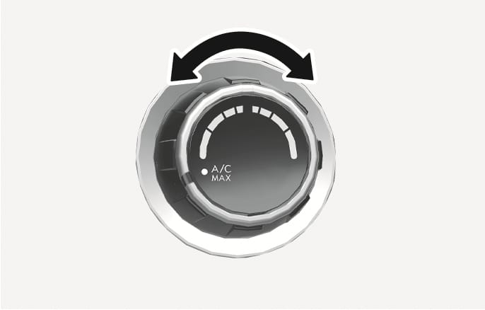 2025 Hyundai Tucson temperature control knob image. A circular knob with a black curved double-headed arrow above it indicates rotational movement. The knob face displays 'A/C MAX' text and white scale markings, explaining the function of adjusting the temperature.