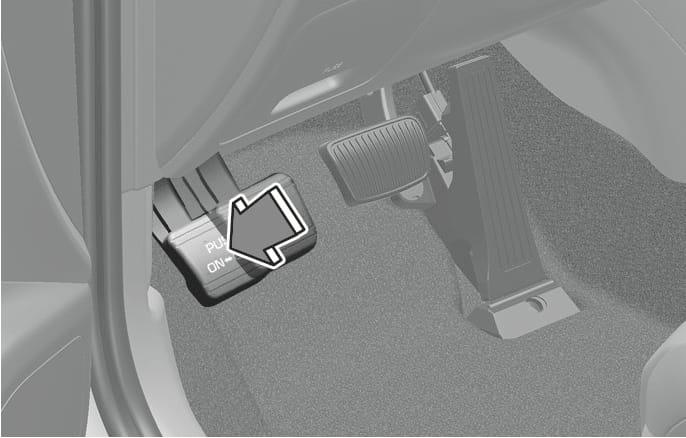 2025 Hyundai Tucson Foot type parking brake applying image. A large downward arrow points to the parking brake pedal located on the far left of the footwell, labeled 'PUSH ON'. This explains the function of engaging the parking brake by depressing the pedal down as far as possible.