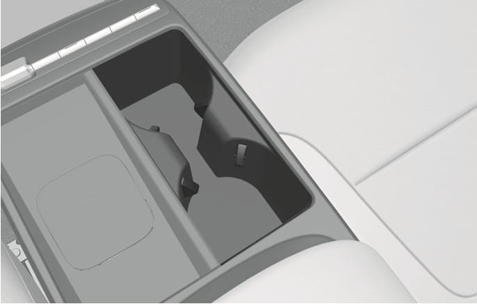 2025 Hyundai Tucson front seat cup holder image. It displays the center console interior with a deep storage bin and a cup holder section equipped with retractable support arms. Explains the function of the cup supporters that protrude to secure beverages.