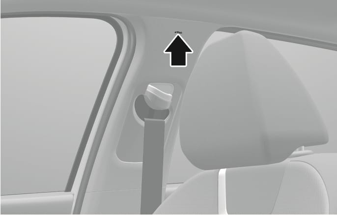 2025 Hyundai Tucson Curtain Airbag Label image. A black arrow with a white outline points to the 'AIRBAG' label embossed on the upper B-pillar trim above the seat belt anchor. Explains the location of the curtain airbag system.