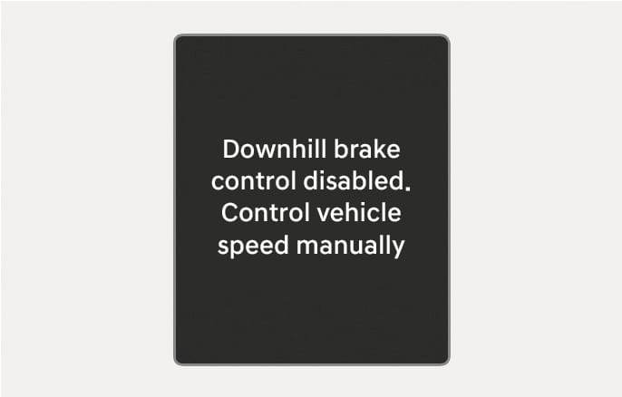 2025 Hyundai Tucson Downhill Brake Control warning image. The instrument cluster displays the text 'Downhill brake control disabled. Control vehicle speed manually'. This explains the warning message that appears when the system is not working properly.