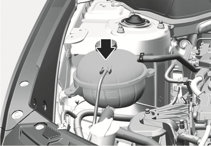 2025 Hyundai Tucson engine coolant reservoir image. A black arrow points downward to the coolant reservoir tank located in the engine compartment. Explains the location of the reservoir for checking the coolant level.