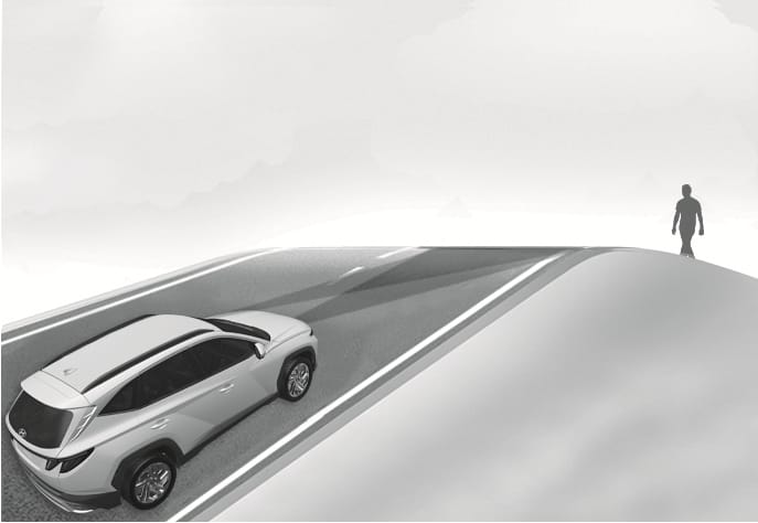 2025 Hyundai Tucson Forward Collision-Avoidance Assist limitation on an inclined road image. A white SUV drives up a steep hill with a pedestrian walking ahead near the crest, positioned outside the sensor's detection range. Explains the limitation where the system may not detect objects on steep slopes.