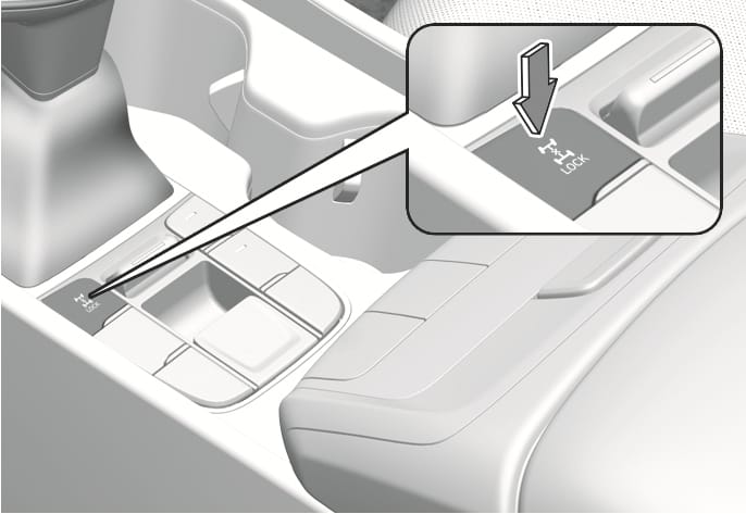 2025 Hyundai Tucson Type B Four Wheel Drive (4WD) Lock button image. The image shows the center console with a detailed view of the 4WD Lock button, featuring a drivetrain icon and 'LOCK' text. A downward arrow indicates pressing the button. Explains the function of activating the 4WD Lock system.