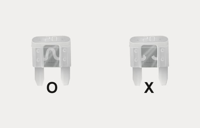 2025 Hyundai Tucson blade type fuse inspection image. The left fuse labeled 'O' shows an intact internal element, while the right fuse labeled 'X' shows a broken or melted element. Explains how to visually identify a blown fuse.