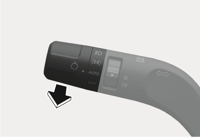2025 Hyundai Tucson high beam flash operation image. The image shows the lighting control lever with a thick black arrow pointing downwards and towards the viewer. Icons for headlights, AUTO, and OFF are visible on the lever. Describes the function of pulling the lever towards the driver to flash the high beam headlights.