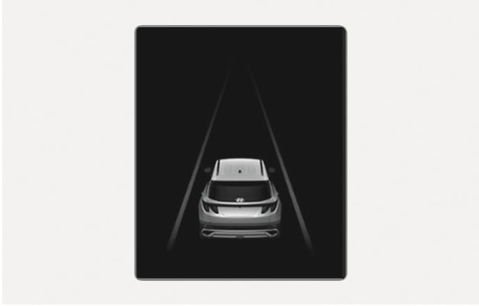 2025 Hyundai Tucson Lane Following Assist display image. The instrument cluster screen shows a rear view of the vehicle with grey lane lines on both sides. This visual indicates the lane undetected state where the system has not recognized the lane markings.