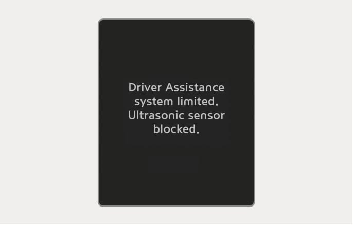2025 Hyundai Tucson Parking Distance Warning disabled warning image. The screen shows the text 'Driver Assistance system limited. Ultrasonic sensor blocked.' on a black background. It explains the warning displayed when ultrasonic sensors are obstructed.