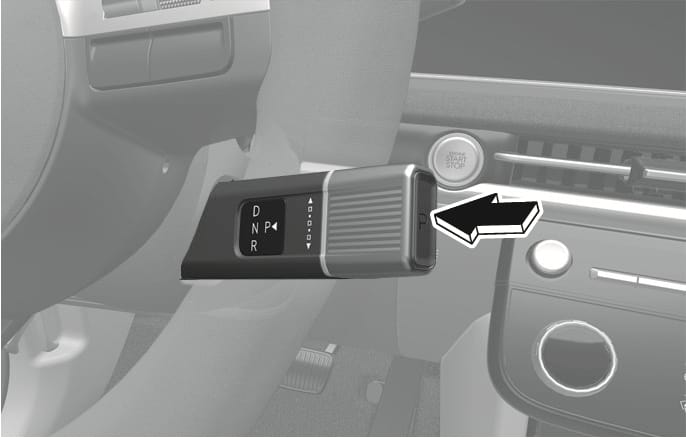2025 Hyundai Tucson gear shift lever P button image. A black arrow indicates the P button on the end of the column-mounted rotary shift lever. The lever displays D, N, and R positions. Explains the function of pressing the button to shift into the P (Park) position.