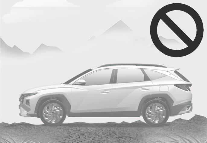 2025 Hyundai Tucson Remote Smart Parking Assist limitation on uneven roads image. The vehicle is depicted on a bumpy surface with fragmented stones, accompanied by a prohibition symbol. Explains the limitation where the parking assist function may not operate properly on uneven terrain.