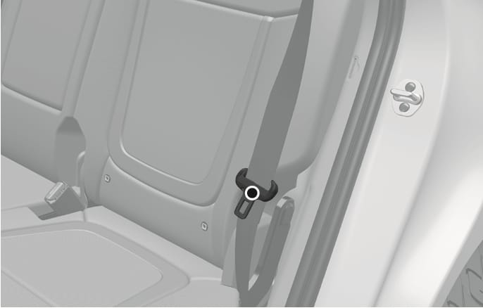 2025 Hyundai Tucson rear seat belt holder image. The image displays the rear seat belt webbing secured in a holder clip on the side interior trim, highlighted by a black circle. Explains the function of positioning the seat belt to the outboard side to prevent interference when folding the rear seatback.