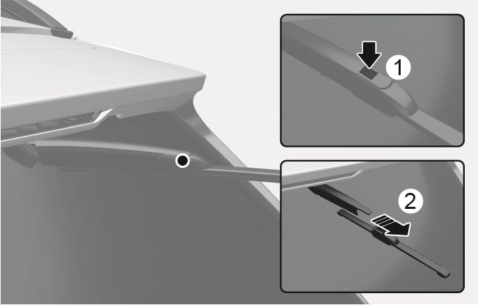 2025 Hyundai Tucson rear wiper blade replacement image. The image shows the rear wiper arm raised from the window. Inset (1) displays a downward arrow indicating to press the release tab, and inset (2) shows a striped arrow indicating to slide the blade assembly out. This explains the function of removing the rear wiper blade.