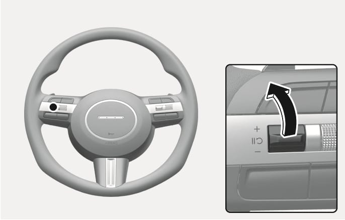 2025 Hyundai Tucson Cruise Control speed increase switch image. The steering wheel displays the control switch on the left spoke. A close-up shows a black arrow pointing upwards, indicating pushing the toggle switch toward the plus (+) symbol. This describes the function of increasing the set cruising speed.