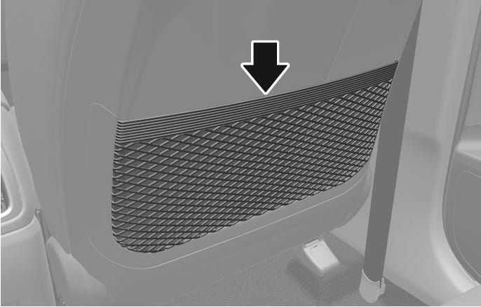 2025 Hyundai Tucson seatback pocket image. The image shows the back of a front seat equipped with a mesh storage pocket. A black arrow points downward towards the pocket opening. This illustrates the location of the seatback pocket for storing small items.
