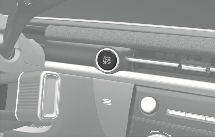 2025 Hyundai Tucson Engine Start/Stop button image. A circular button labeled 'ENGINE START STOP' is located on the dashboard to the right of the steering wheel. Describes the control used to start or stop the engine and change ignition modes.