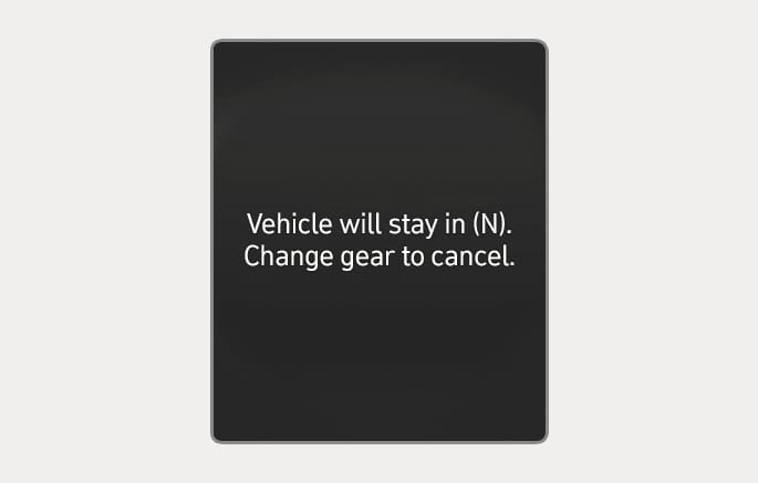 2025 Hyundai Tucson cluster display message image. The screen shows the text 'Vehicle will stay in (N). Change gear to cancel.' in white letters on a black background. It explains the function indicating the gear remains in Neutral (N) after the engine is turned off.
