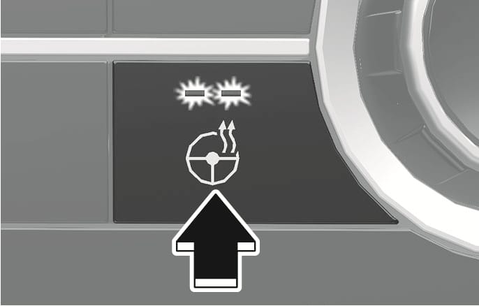 2025 Hyundai Tucson heated steering wheel button image. The button features a steering wheel icon with wavy heat lines and two indicator lights above it. A black arrow points upward, indicating the action of pressing the button to activate the steering wheel heater.