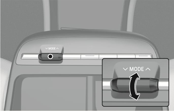 2025 Hyundai Tucson Drive Mode selector switch image. The image displays the 'MODE' toggle switch located on the center console. A zoomed-in inset shows a black double-headed curved arrow indicating the switch can be moved up or down. Explains the function of selecting drive modes by toggling the switch.