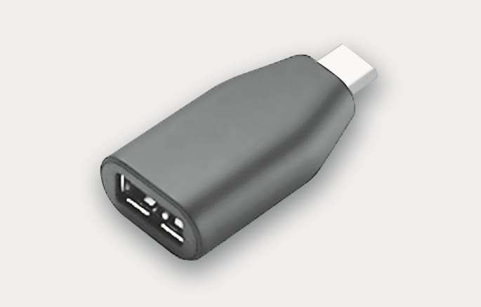 2025 Hyundai Tucson USB converting adapter image. The image displays a black adapter featuring a USB-C plug on one end and a USB-A port on the other. It describes the use of a genuine C to A type adapter for connecting Type-A USB devices to the vehicle.