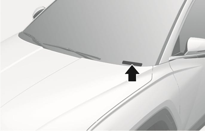 2025 Hyundai Tucson VIN location image. A black arrow points to the VIN plate on the dashboard, visible through the lower windshield. Explains the location of the VIN plate that can be checked from outside the vehicle.