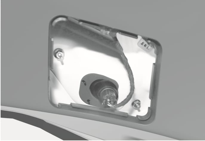 2025 Hyundai Tucson Tail light (Inside) socket image. The image shows the rear of the light assembly inside the tailgate, featuring a bulb socket with a connected wire harness inserted into the white housing. It illustrates the component to be rotated counterclockwise to remove the socket for bulb replacement.