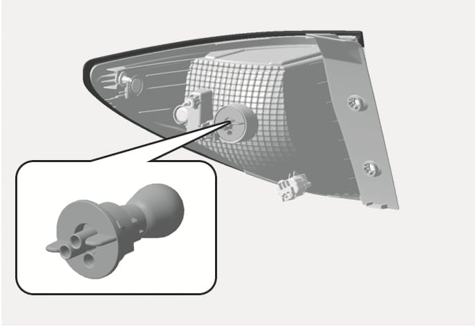 2025 Hyundai Tucson rear combination light socket image. The diagram displays the rear of the light assembly with a magnified callout showing the bulb socket's shape and tabs. This illustrates the component to be removed for replacing the stop and tail light bulb.
