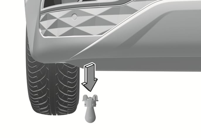 2025 Hyundai Tucson rear bumper light replacement image. A downward arrow indicates the removal direction of the bulb socket from the underside of the rear bumper near the tire. Explains the process of replacing the turn signal, rear fog, or back-up light.