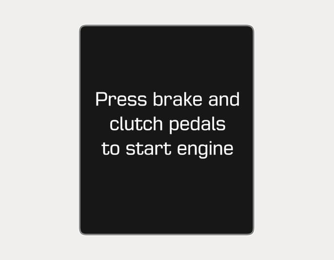 2025 Hyundai Tucson instrument cluster display image. The screen displays the white text 'Press brake and clutch pedals to start engine' on a black background. This explains the procedure to start the engine for manual transmission vehicles.