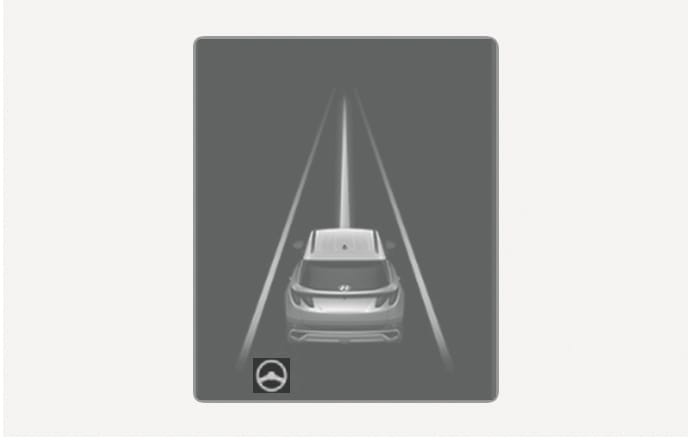 This is an image of the 2025 Hyundai Tucson cluster display. Lane lines are displayed in white on both sides of the rear graphics, and a steering wheel icon is located in the lower left corner. This explains the screen layout when the Lane Keeping Assist function has properly recognized the lanes.