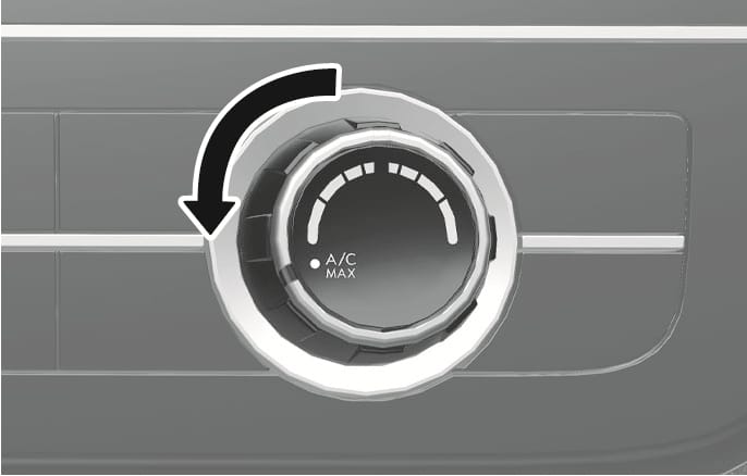 This is an image of the maximum cooling setting knob for the 2025 Hyundai Tucson. The temperature control knob is marked with the words "A/C MAX," and a black curved arrow indicates turning the knob to the left. This explains how to use the knob to set the maximum cooling function.